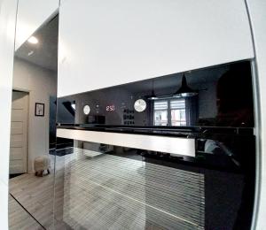 a kitchen with a stove top oven in a room at Apartament nad Jeziorem in Olecko