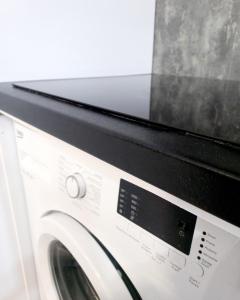 a microwave sitting on top of a washing machine at Apartament nad Jeziorem in Olecko