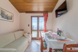 una sala de estar con una mesa y un sofá en Apartmani Villa Bose, en Celina