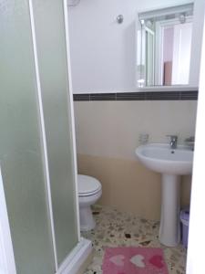 a bathroom with a toilet and a sink at Carpe Diem Apartments in Castellammare del Golfo +33 photos