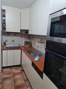 a kitchen with a sink and a microwave at Sara in Mostar