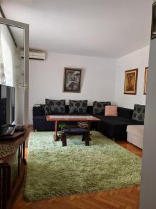 a living room with a couch and a table at Sara in Mostar