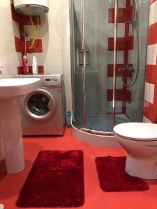 a bathroom with a shower and a washing machine at Orbi Towers Batumi in Batumi