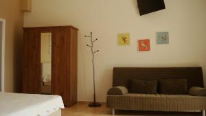 a bedroom with a bed and a couch at Merlot Village Rental Apartments in Kariá