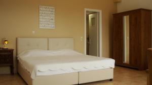 a bedroom with a white bed in a room at Merlot Village Rental Apartments in Kariá