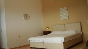a bedroom with a white bed in a room at Merlot Village Rental Apartments in Kariá