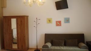 a living room with a couch and a mirror at Merlot Village Rental Apartments in Kariá