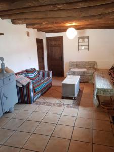 a living room with two couches and a table at Granja de Matias in Cádiar
