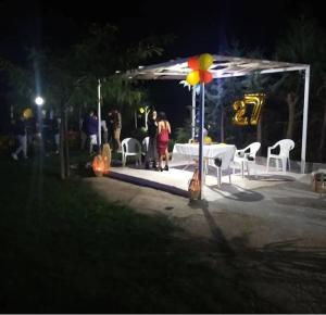 a group of people standing under a gazebo at night at B&B il giardino di Eolo in Pietramelara