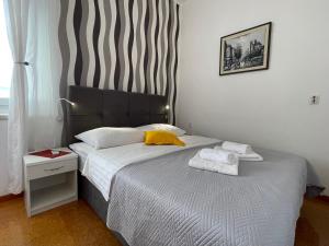 a bedroom with a bed with two towels on it at Accommodation Jarula in Zadar
