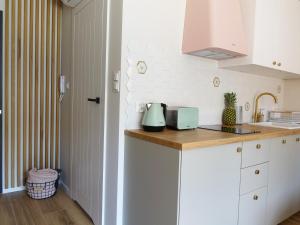 a kitchen with white cabinets and a counter top at Apartament Carmel Stegna Park in Stegna