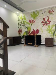 a room with a flower mural on the wall at Independent Villa in DHA Phase 6 Lahore Three 3 Bedroom Full House in Lahore