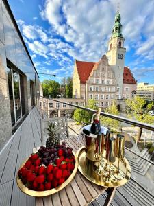 a plate of fruit on a table on a balcony at Golden Apartments Centrum in Olsztyn