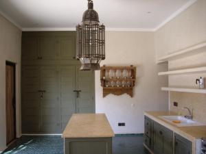 a kitchen with a bird cage hanging from a ceiling at Dar al Hossoun in Taroudant