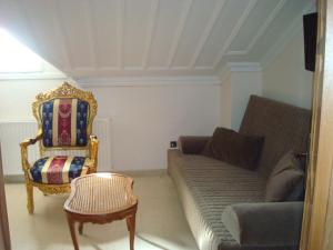 a living room with a couch and a chair at Merlot Village Rental Apartments in Kariá