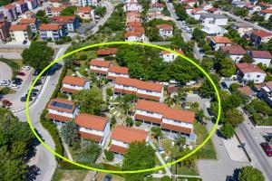 an aerial view of a suburb with a yellow circle at Villas Corinthia in Baška