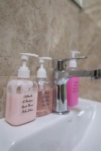 a bathroom sink with two soap bottles on it at Hotel Siddharth A Boutique Guest House in New Delhi