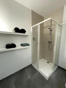 a shower stall with a glass door in a bathroom at Le GreenStairs - Ranch du Laubenrain in Jungholtz