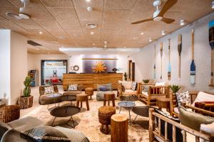 a lobby with couches and tables and chairs at Almogim Suites Eilat in Eilat