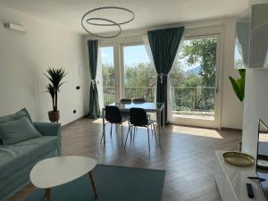 a living room with a couch and a table and chairs at Villa antonini. in Lerici