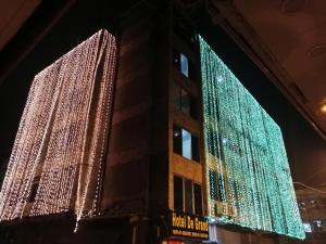 two tall buildings are decorated with christmas lights at HOTEL DE GRAND in Rawalpindi