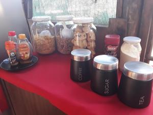 a red table with jars of food and other foods at Shik Shack Backpackers in Guernsey Nature Reserve