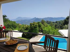 una mesa con comida en el balcón con vistas en Villa VERA - private villa for 8 guests with pool, en Kími
