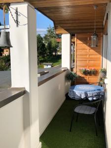 an outdoor patio with a table and a bench at Agnes Apartman in Latschach