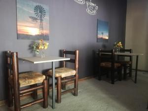 a dining room with two tables and two chairs at AshTree GuestHouse in Hanover