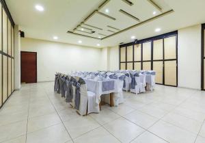 帕斯托Hotel Basan Plaza的房间里有桌椅的宴会厅