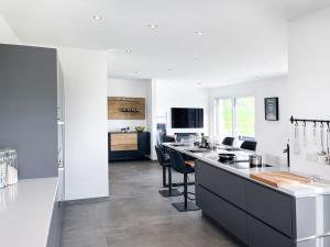 a kitchen with a counter and chairs in a room at The View Suite in Brücktal