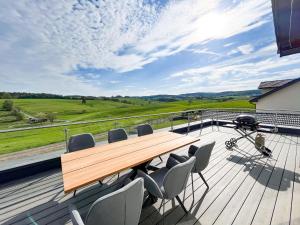 a wooden table and chairs sitting on a deck at The View Suite in Brücktal