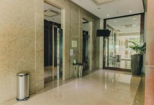 a hallway of a building with a potted plant at Ayala Mall 10mins walk Cebu City Apartment & Pool in Cebu City +42 photos