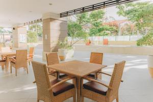 a patio with a table and chairs in a restaurant at Ayala Mall 10mins walk Cebu City Apartment & Pool in Cebu City