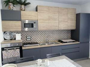 a kitchen with a sink and a stove top oven at casa Marinello B in Oliveri