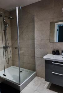 a shower with a glass door in a bathroom at Bałtyk 44 na Wydmach in Międzywodzie +21 photos