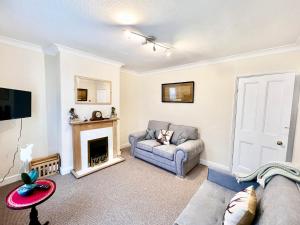 a living room with a couch and a fireplace at 10 Langworthgate in Lincoln
