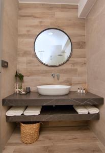 a bathroom with a sink and a mirror at Nostalgia Suites in Faliraki +33 photos
