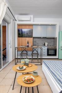 a kitchen and living room with a table with food on it at Nostalgia Suites in Faliraki