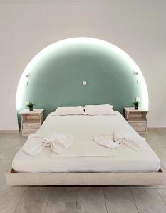 a bedroom with a bed with an arch overhead at Sea Harmony in Kalathos