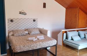 a bed with two pillows and a chair in a room at MAS BLANC in Calafell +20 photos