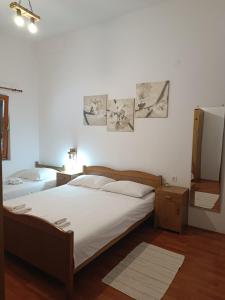 a bedroom with two beds and two pictures on the wall at Apartments Branka- 4 apartments in house- 1 apartment has jacuzzi in Vir