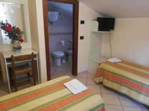 A bed or beds in a room at Hotel Grazia Ristorante
