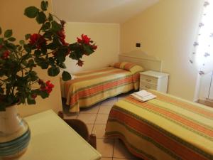 A bed or beds in a room at Hotel Grazia Ristorante