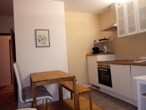 a small kitchen with a wooden table and a table and a table at Gössl, Apartement und Doppelzimmer in Mariazell