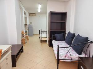 a living room with a couch and a kitchen at tripoli central accommodation in Tripolis