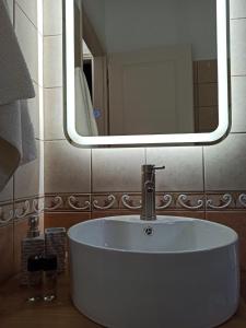 a white sink in a bathroom with a mirror at Olivo Nydri in Nydri