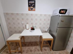 a small kitchen with a table and a refrigerator at Birchwood place in Sarajevo