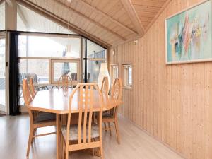 a dining room with a wooden table and chairs at Holiday home Slagelse XX in Slagelse
