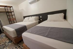 a bedroom with two beds and a ladder at HOTEL BRANA in Medellín